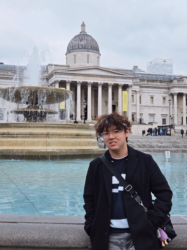 Standing by the fountain in front of the National Gallery in London
