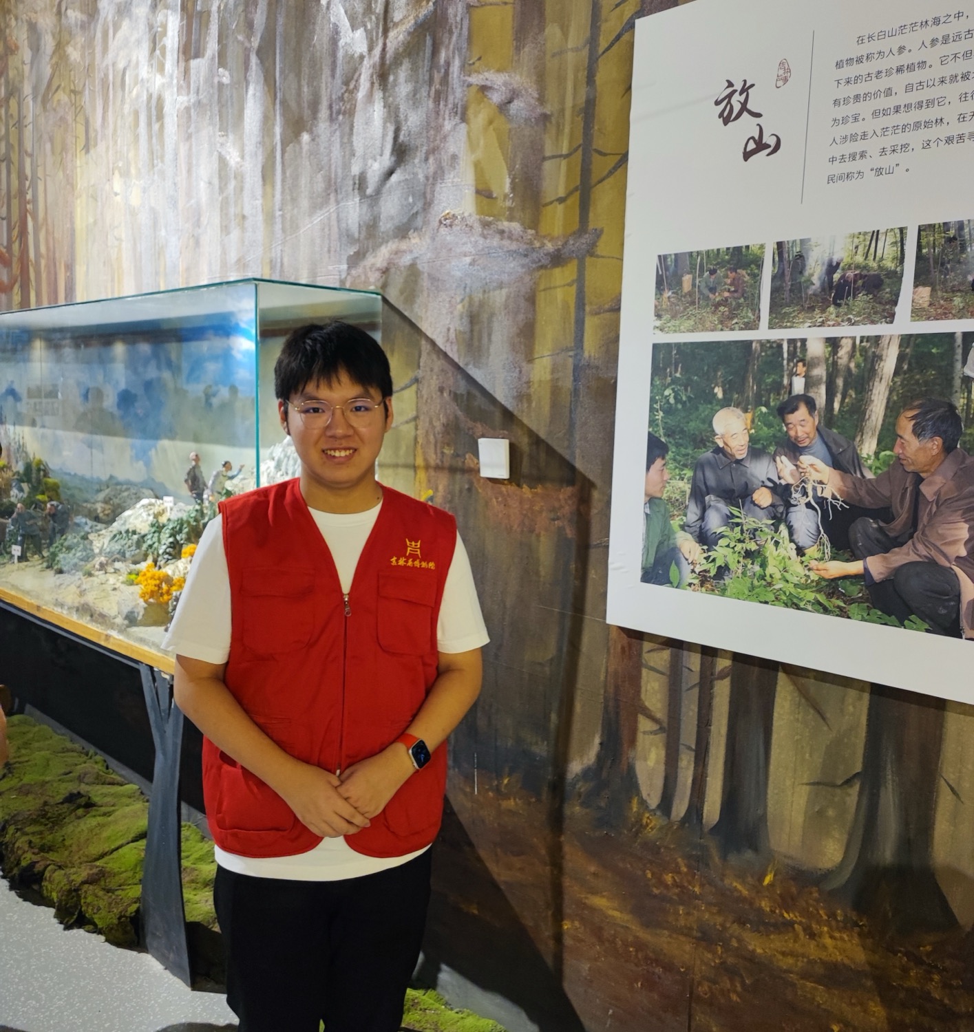 Standing beside a forest diorama in the museum gallery