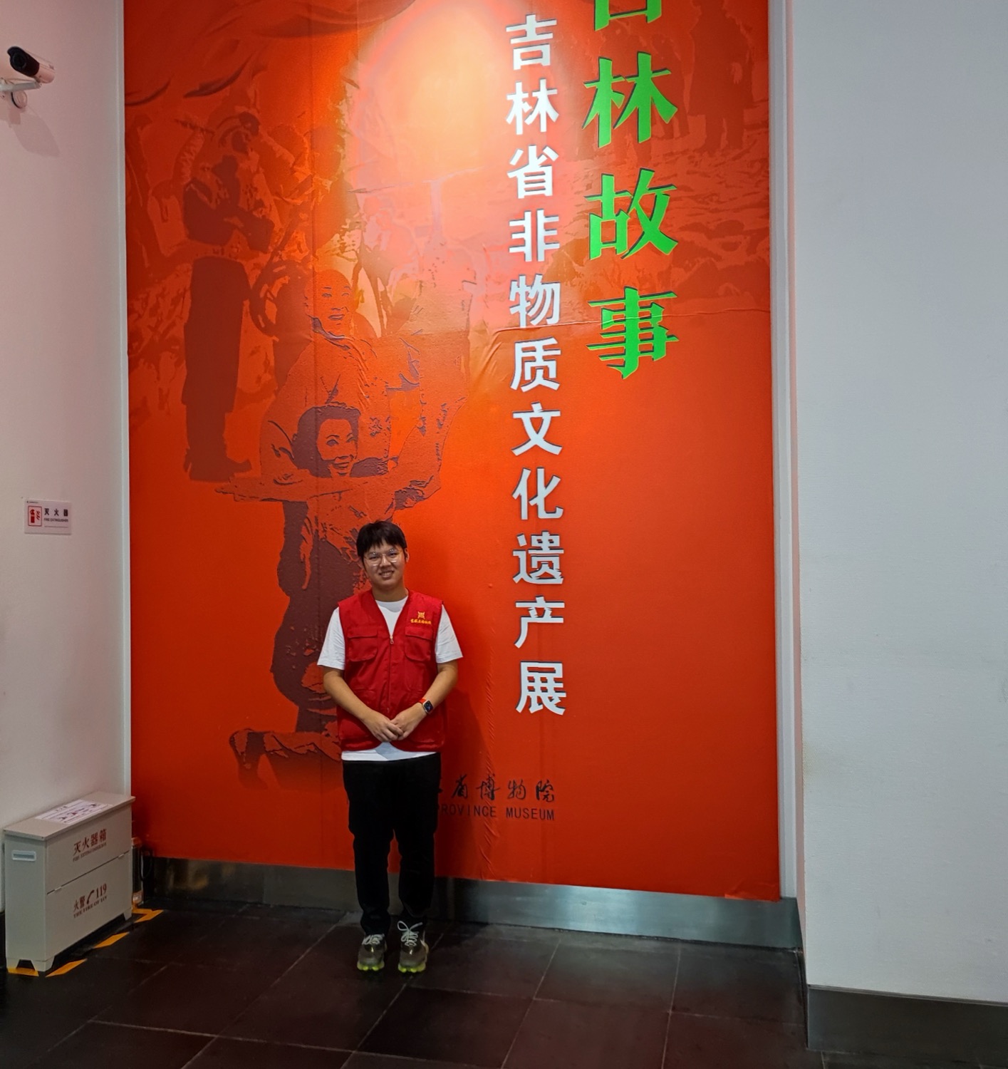 Standing in front of the Jilin Stories intangible cultural heritage exhibition