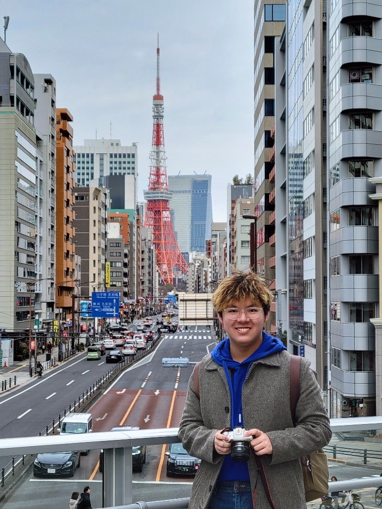 Standing on a pedestrian bridge with Tokyo Tower behind